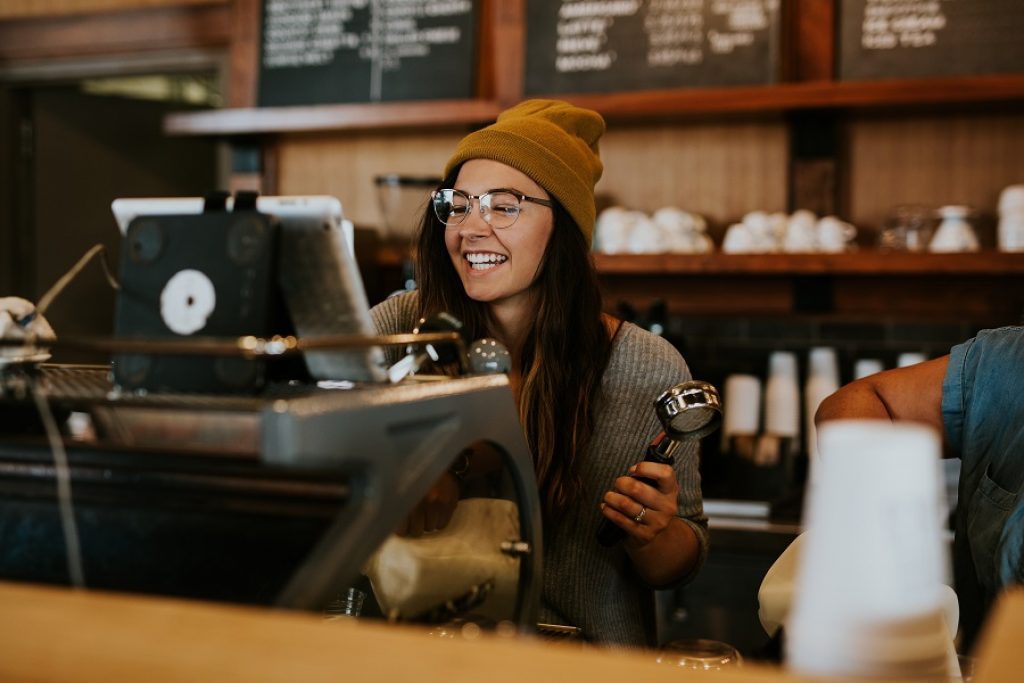 A barista rings up a customer