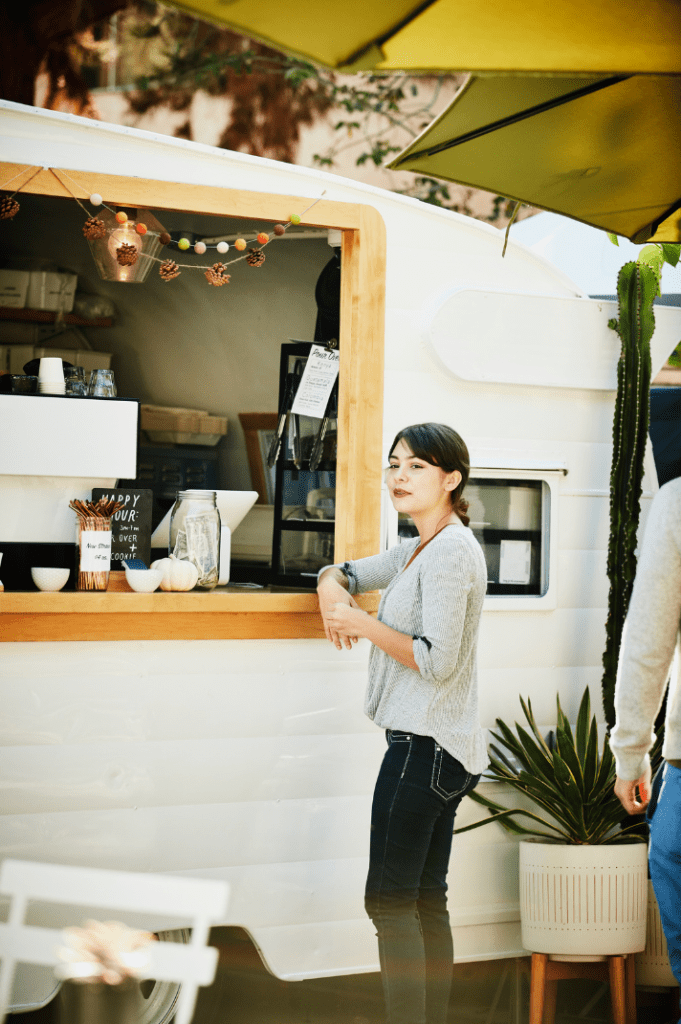 A customer at a coffee trailer waits for her coffee.