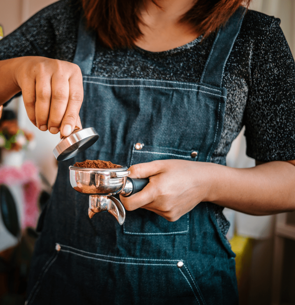 A barista serving espresso.