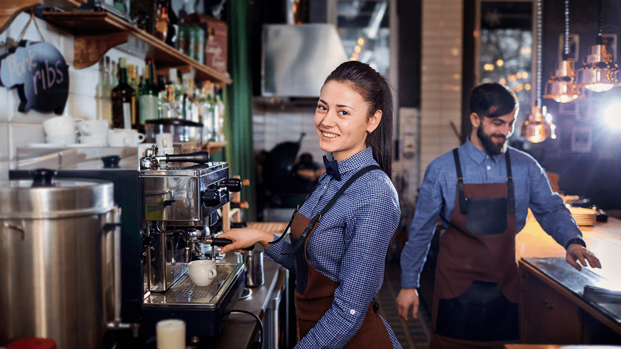 A barista smile while serving coffee