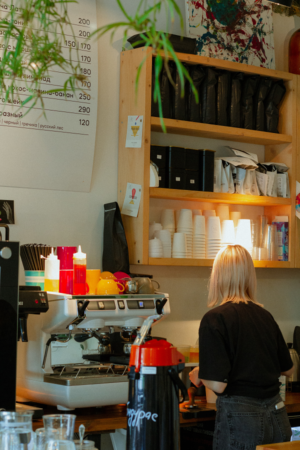 A barista serves coffee after taking a coffee shop business class. 