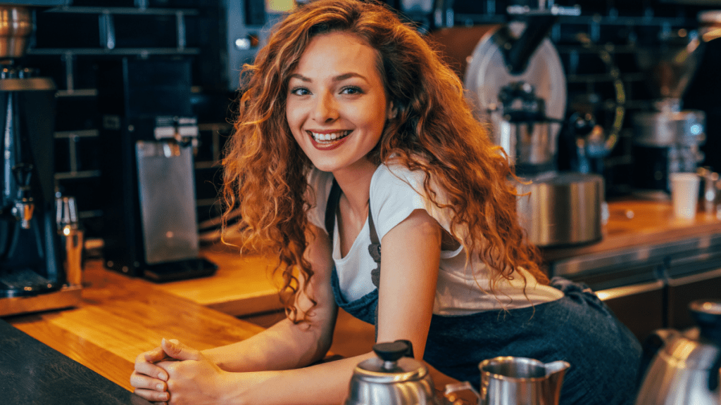 A barista in Nebraska smiles at customers.