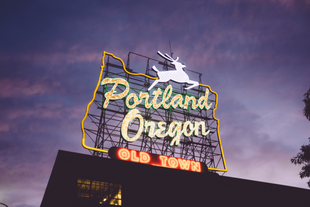 Portland, Oregon sign shines in the Portland sky.