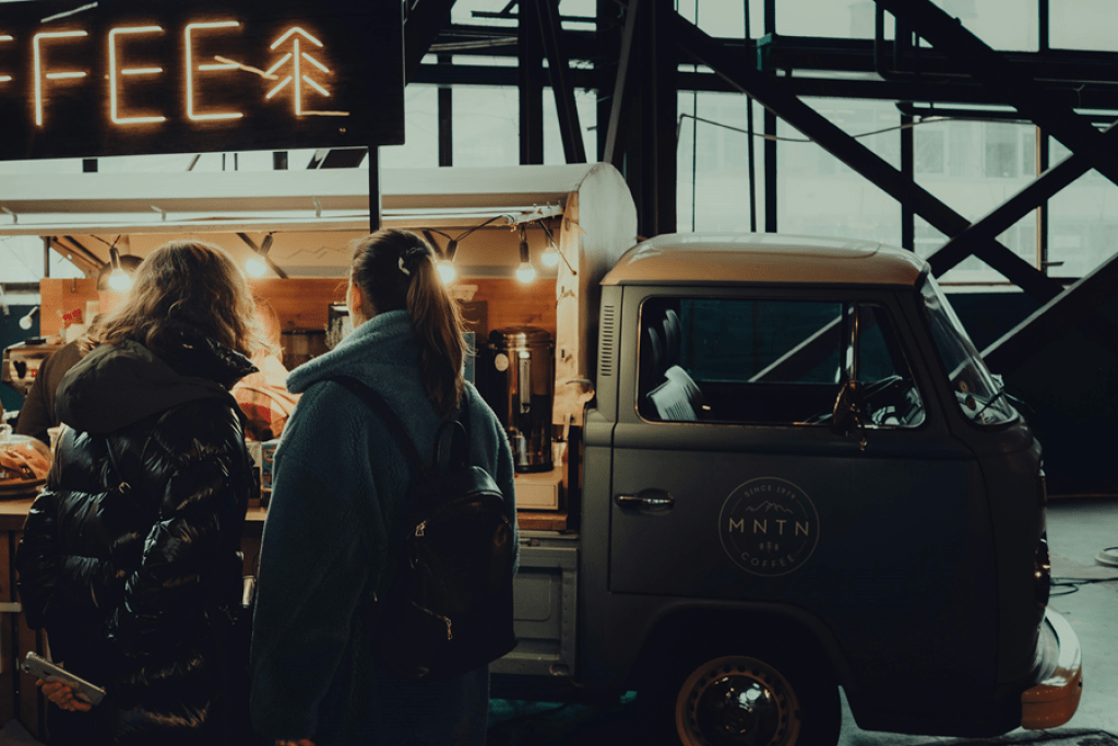 Coffee van serves customers coffee. 